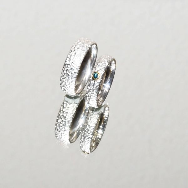 Eheringe aus Silber mit strukturierter Oberfläche und Brillant - blau behandelt in Gold gefasst